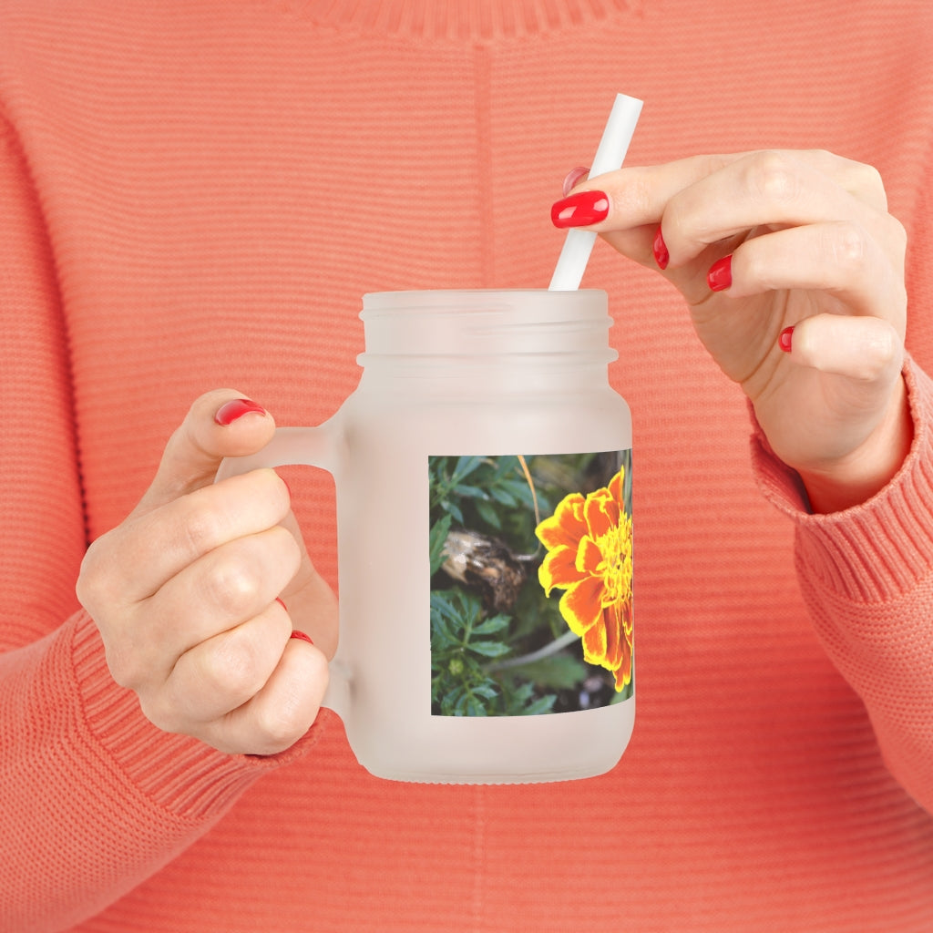 A vibrant Red and Yellow Flower Mason Jar with a straw and lid, showcasing its frosted glass design and floral pattern.