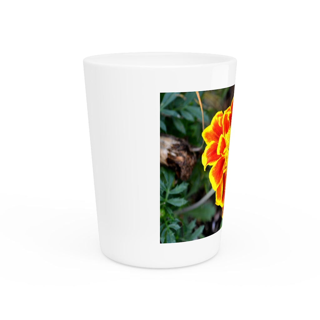 Ceramic shot glass featuring a vibrant red and yellow flower design, available with white or black interior.