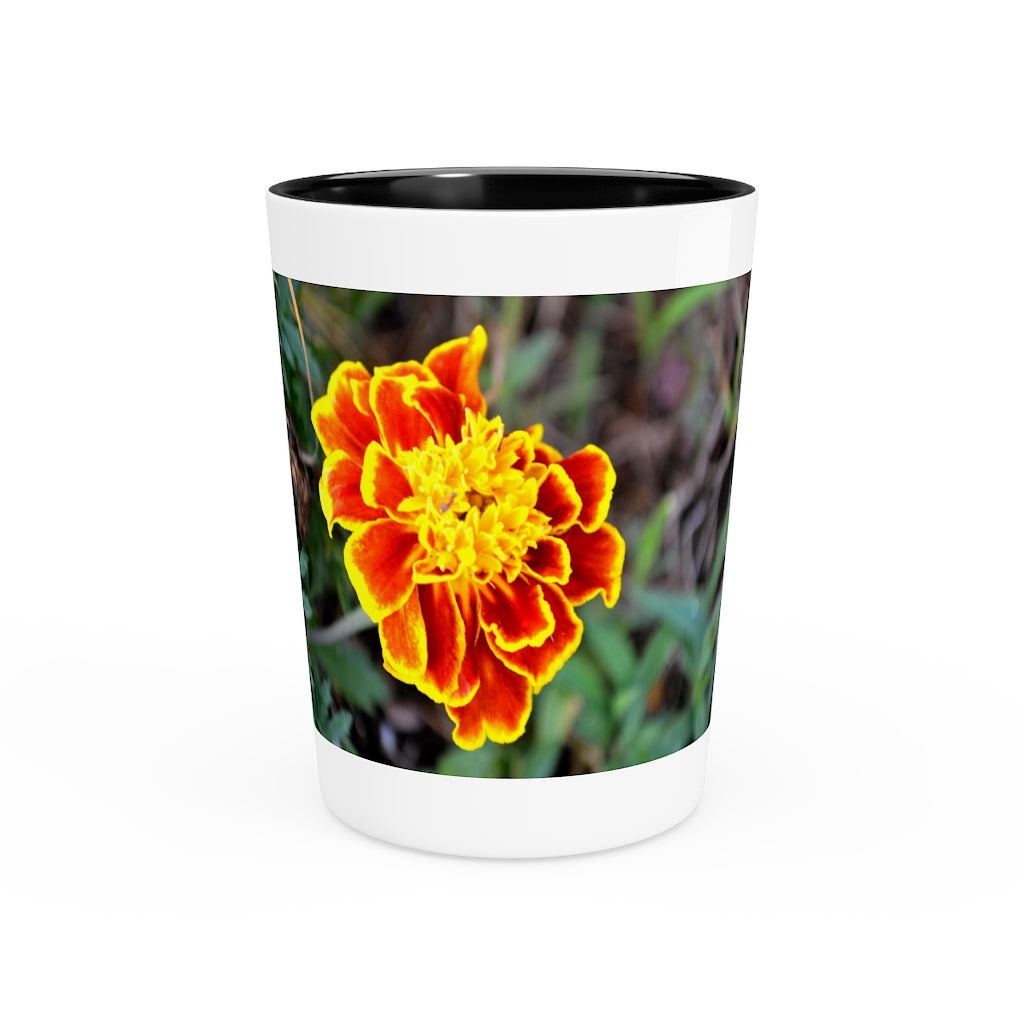 Ceramic shot glass featuring a vibrant red and yellow flower design, available with white or black interior.