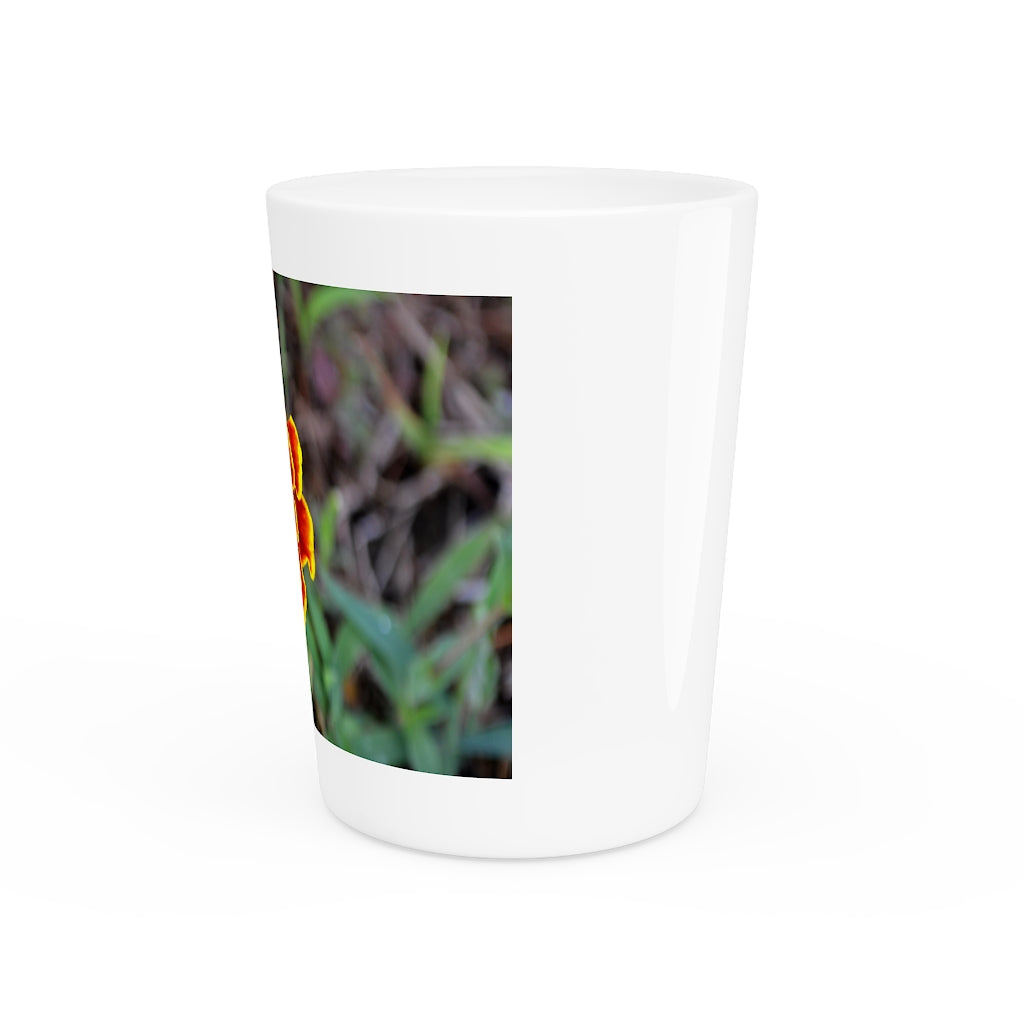 Ceramic shot glass featuring a vibrant red and yellow flower design, available with white or black interior.