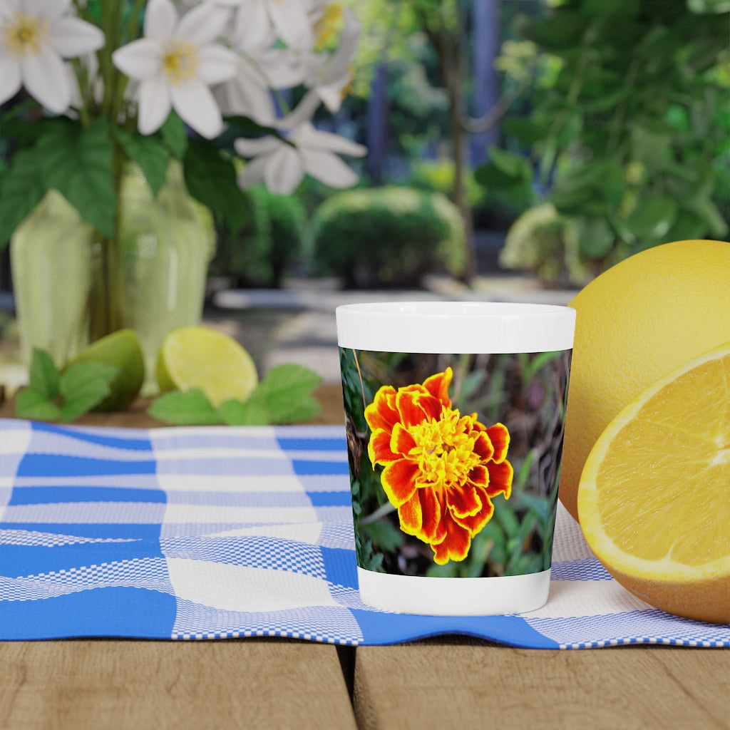 Ceramic shot glass featuring a vibrant red and yellow flower design, available with white or black interior.