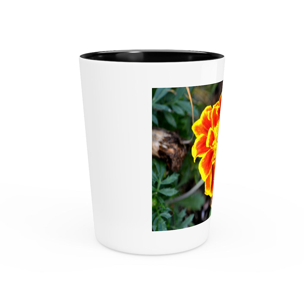 Ceramic shot glass featuring a vibrant red and yellow flower design, available with white or black interior.