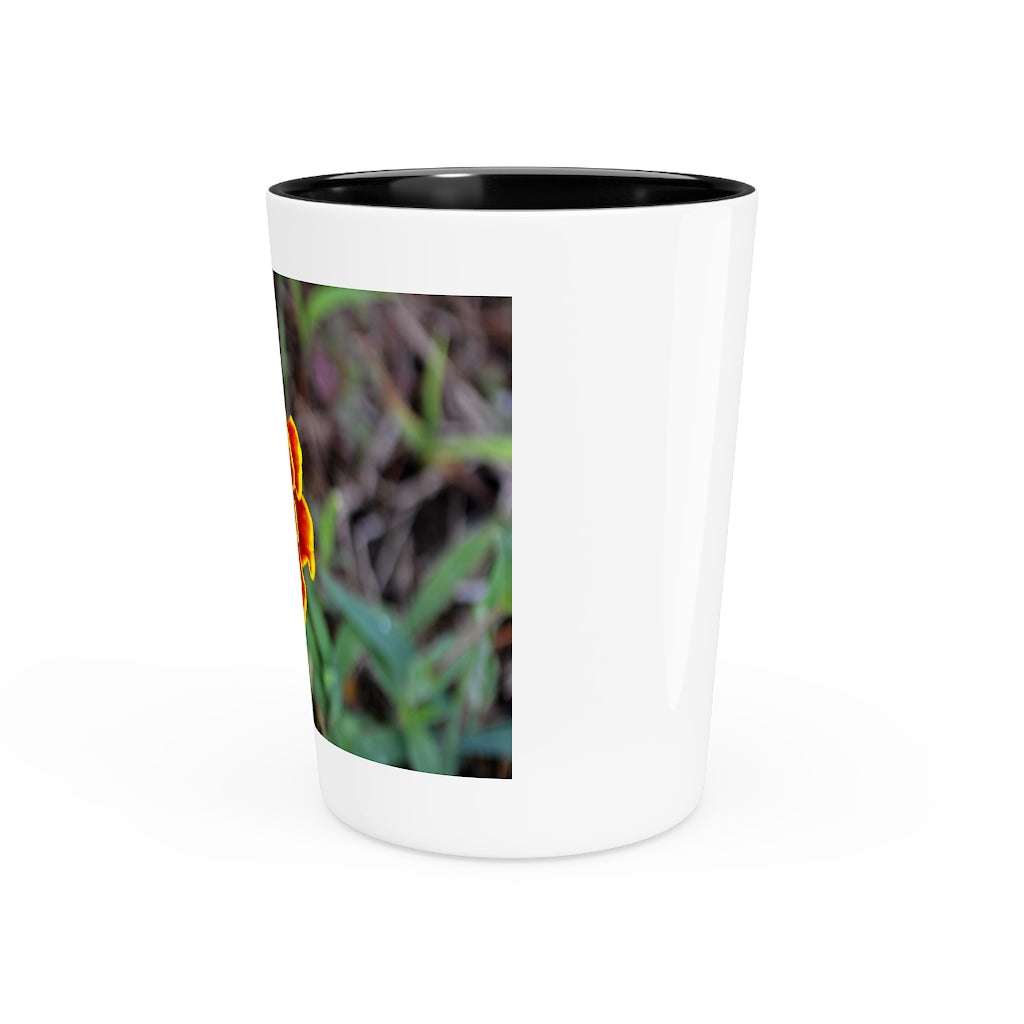 Ceramic shot glass featuring a vibrant red and yellow flower design, available with white or black interior.