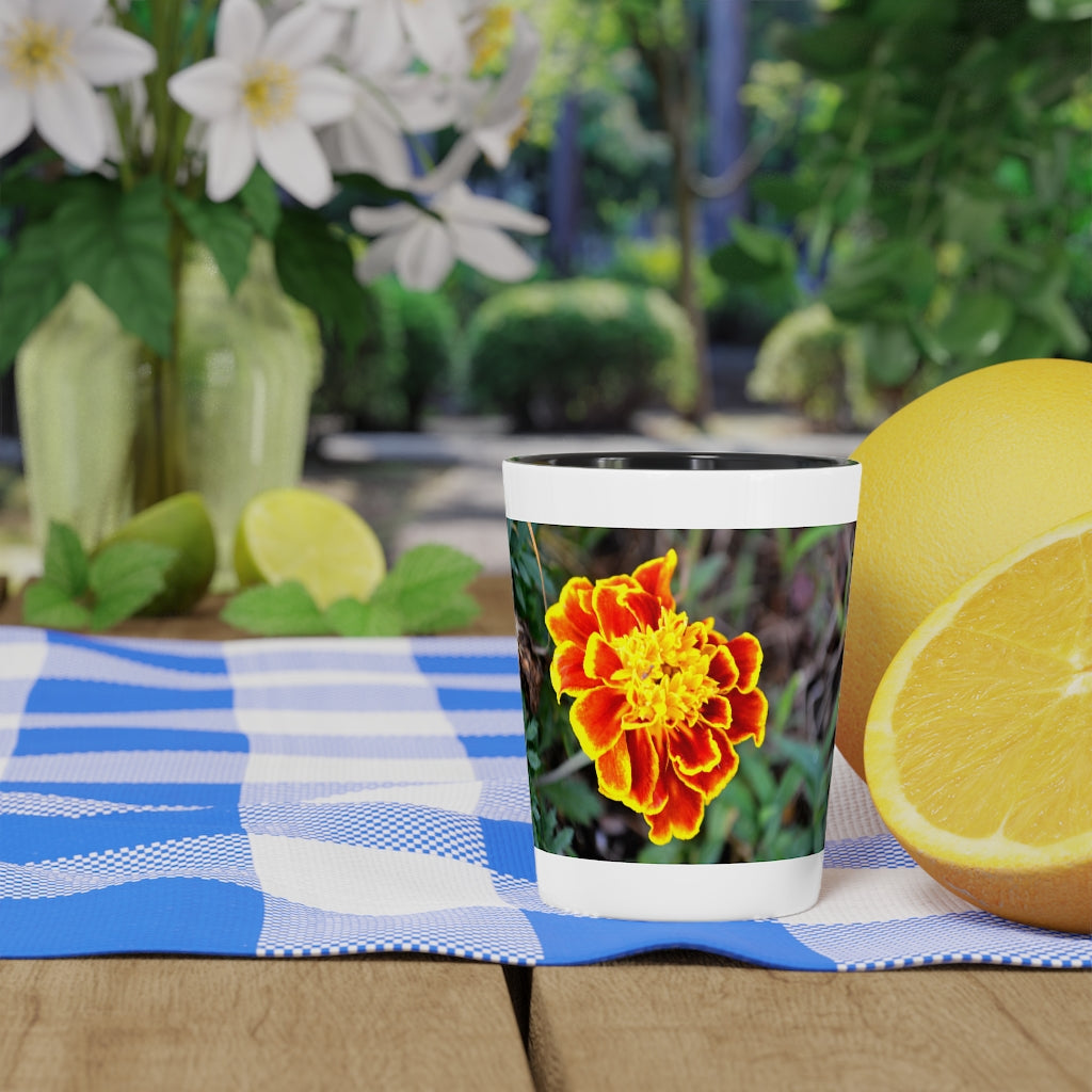 Ceramic shot glass featuring a vibrant red and yellow flower design, available with white or black interior.