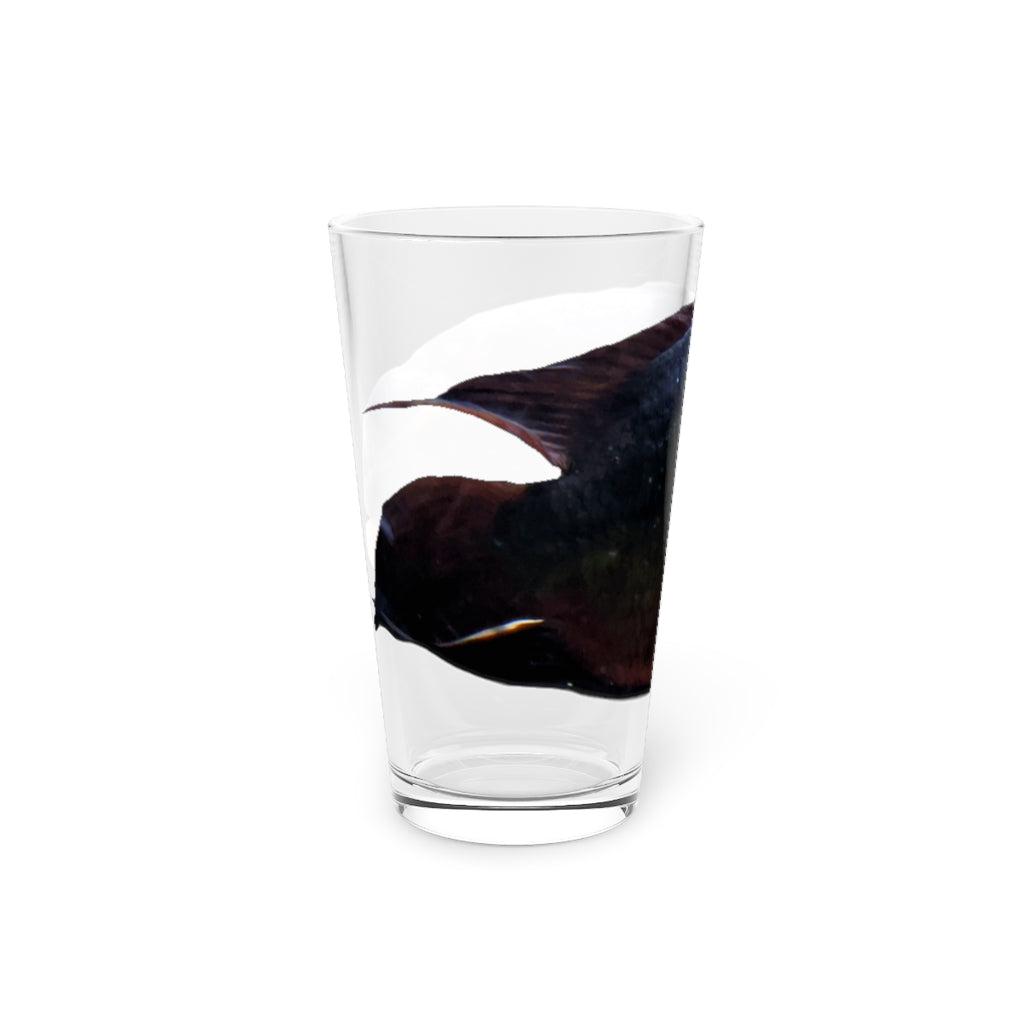 A clear 16oz pint glass featuring a red and black fish design, perfect for personalized beverages.