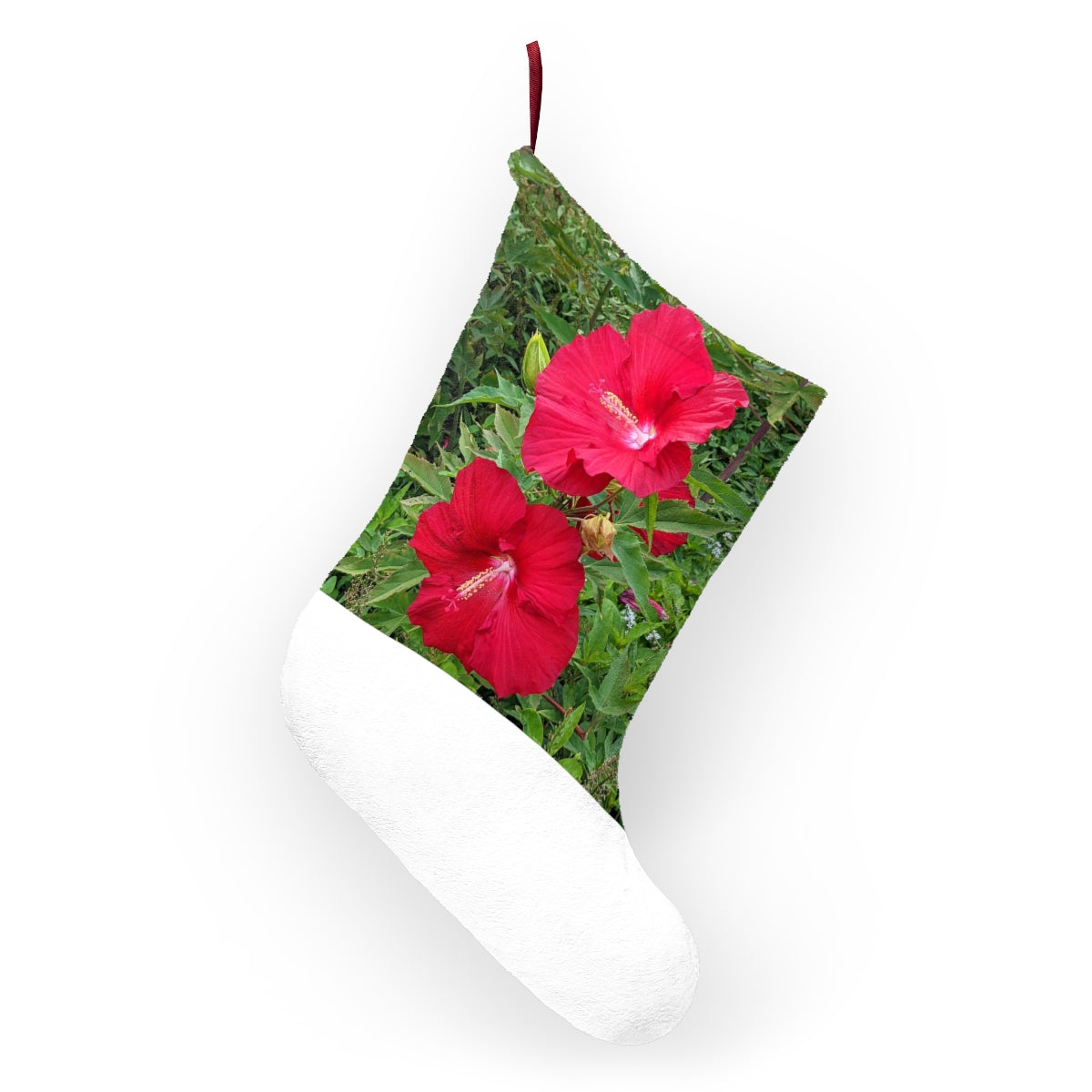 A pair of vibrant red flowers Christmas stockings hanging by a fireplace, showcasing their soft fleece material and personalized design.