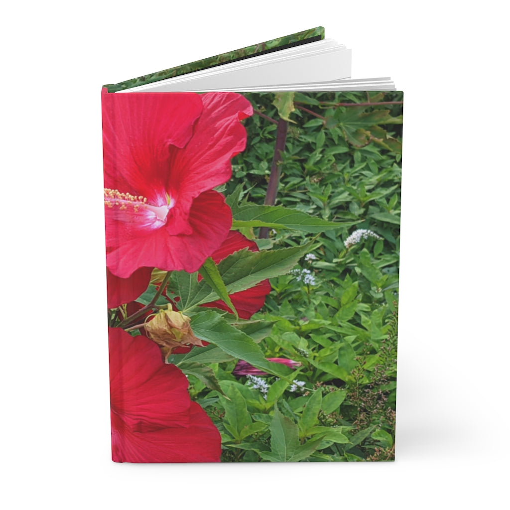 A beautifully designed Red Flowers Hardcover Journal with a matte finish, featuring vibrant floral patterns on the cover.