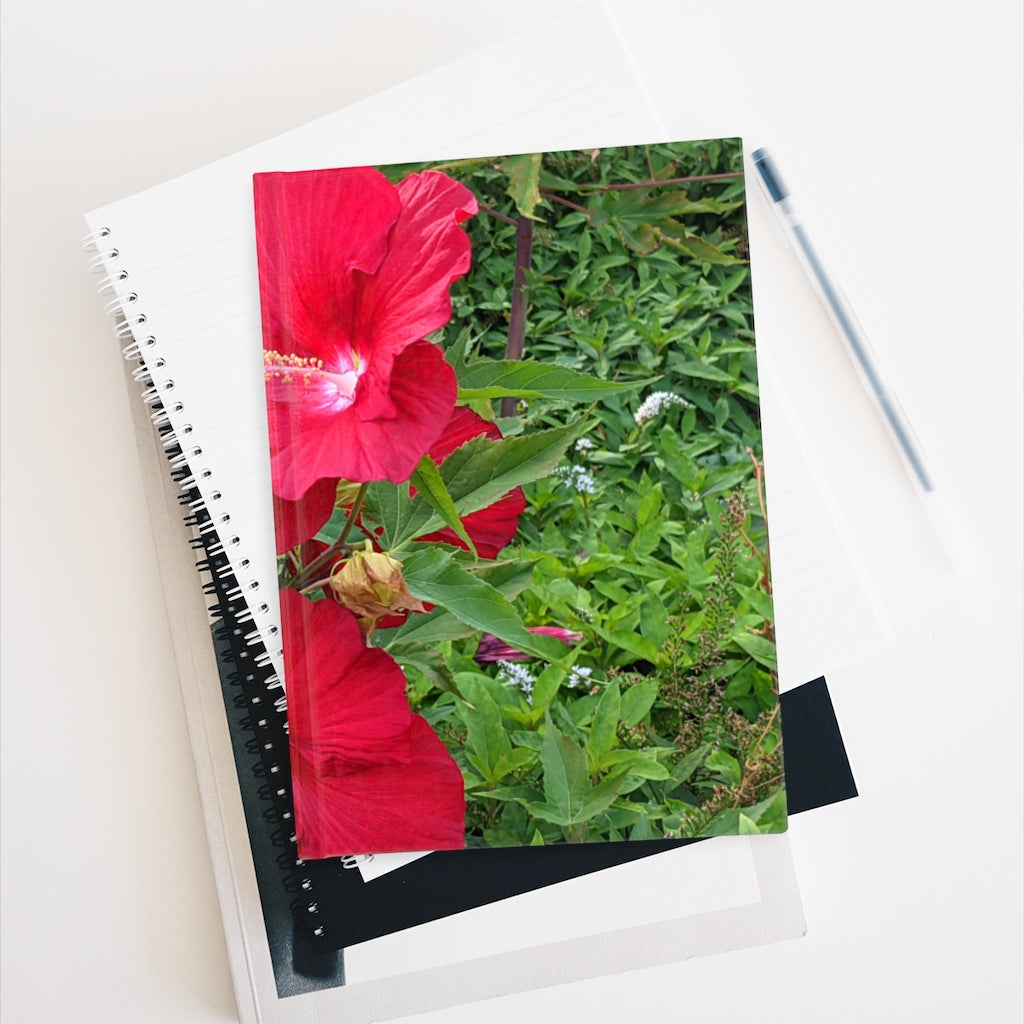 A hardcover journal featuring a vibrant red flowers design, showcasing its blank pages and durable casewrap binding.