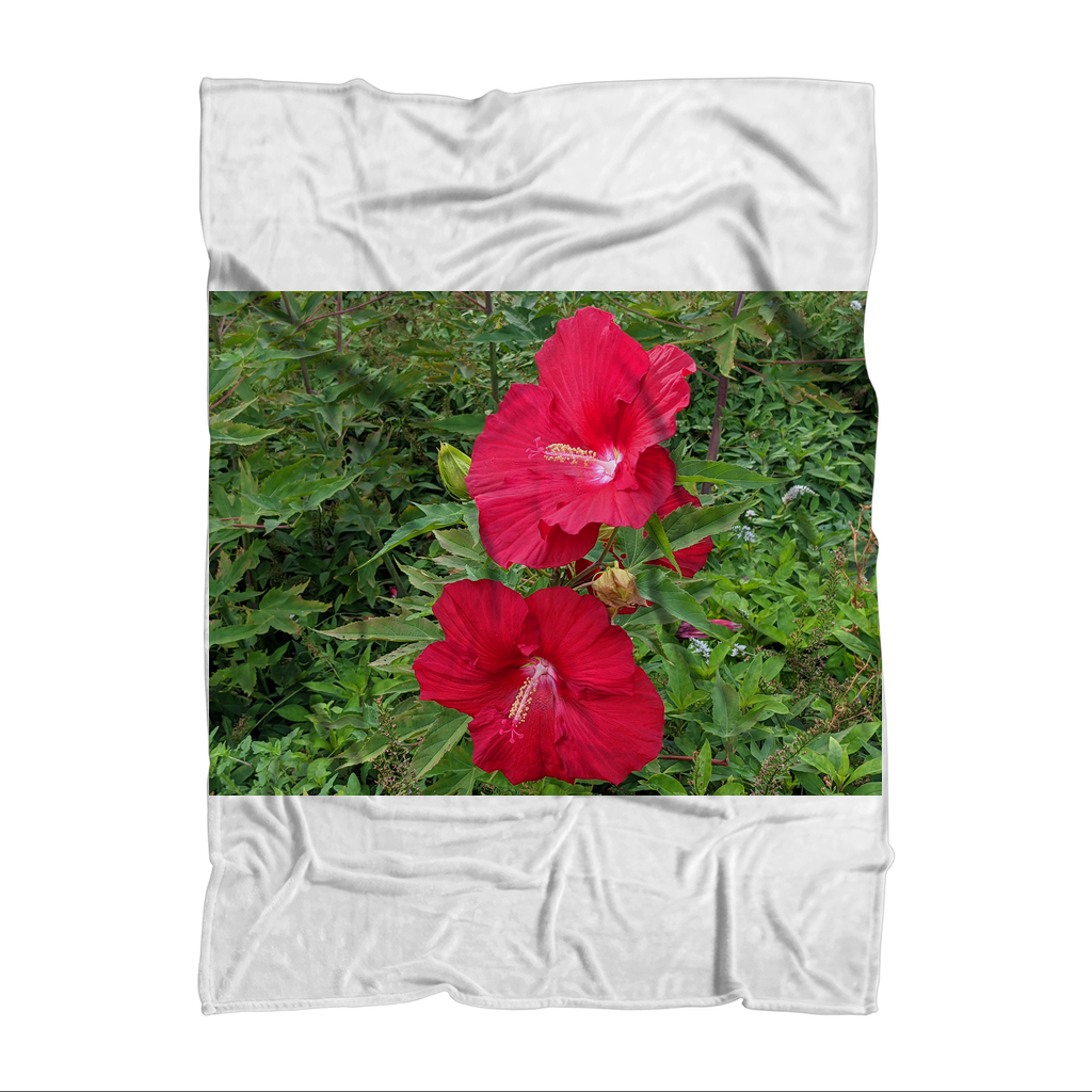 A cozy Red Flowers Sublimation Throw Blanket featuring vibrant floral patterns on soft fleece fabric, perfect for home decor.