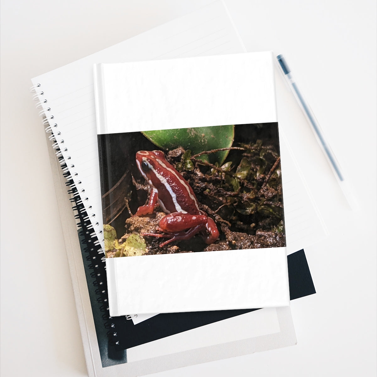 Red Frog Journal with blank pages and vibrant wraparound print, showcasing its durable hardcover design.