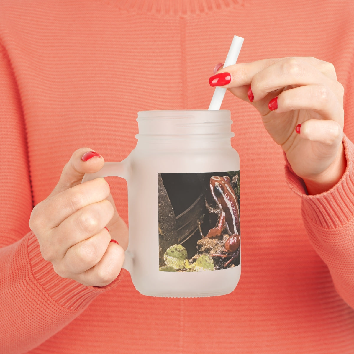 A stylish Red Frog Mason Jar made of frosted glass, featuring a straw and lid, perfect for personalized drinks.