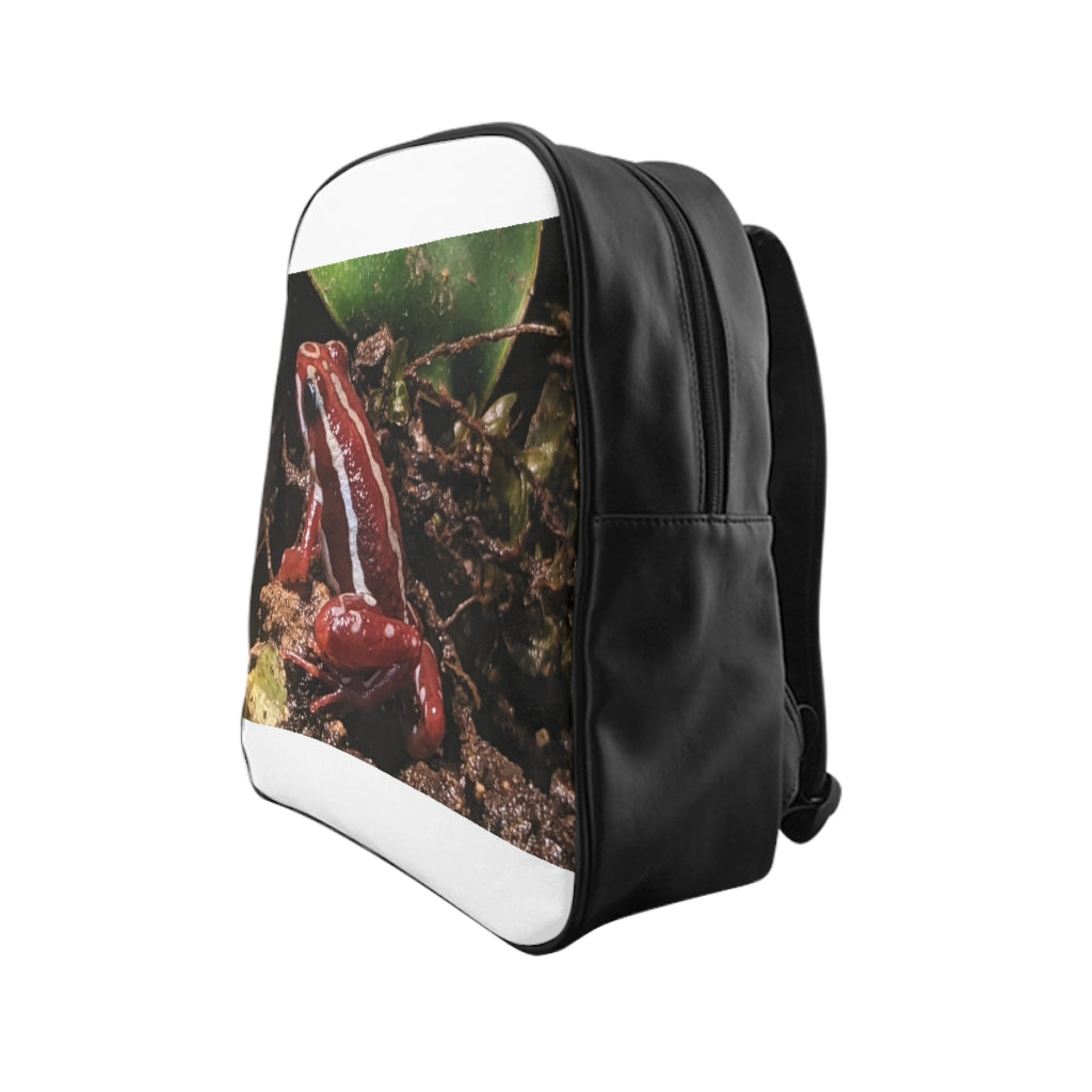 Red Frog School Backpack featuring a vibrant frog design, padded back, and multiple inside pockets, made from durable PU leather.