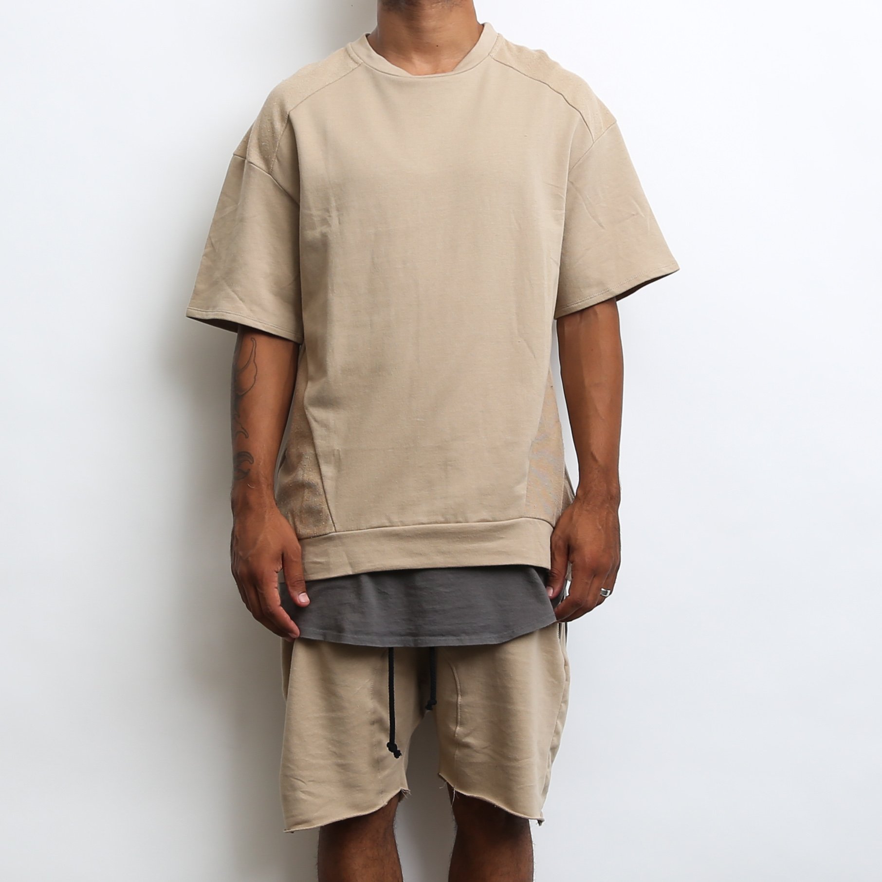 Khaki oversized 1/2 sleeve tee made from 100% cotton, showcasing a relaxed fit and stylish design.