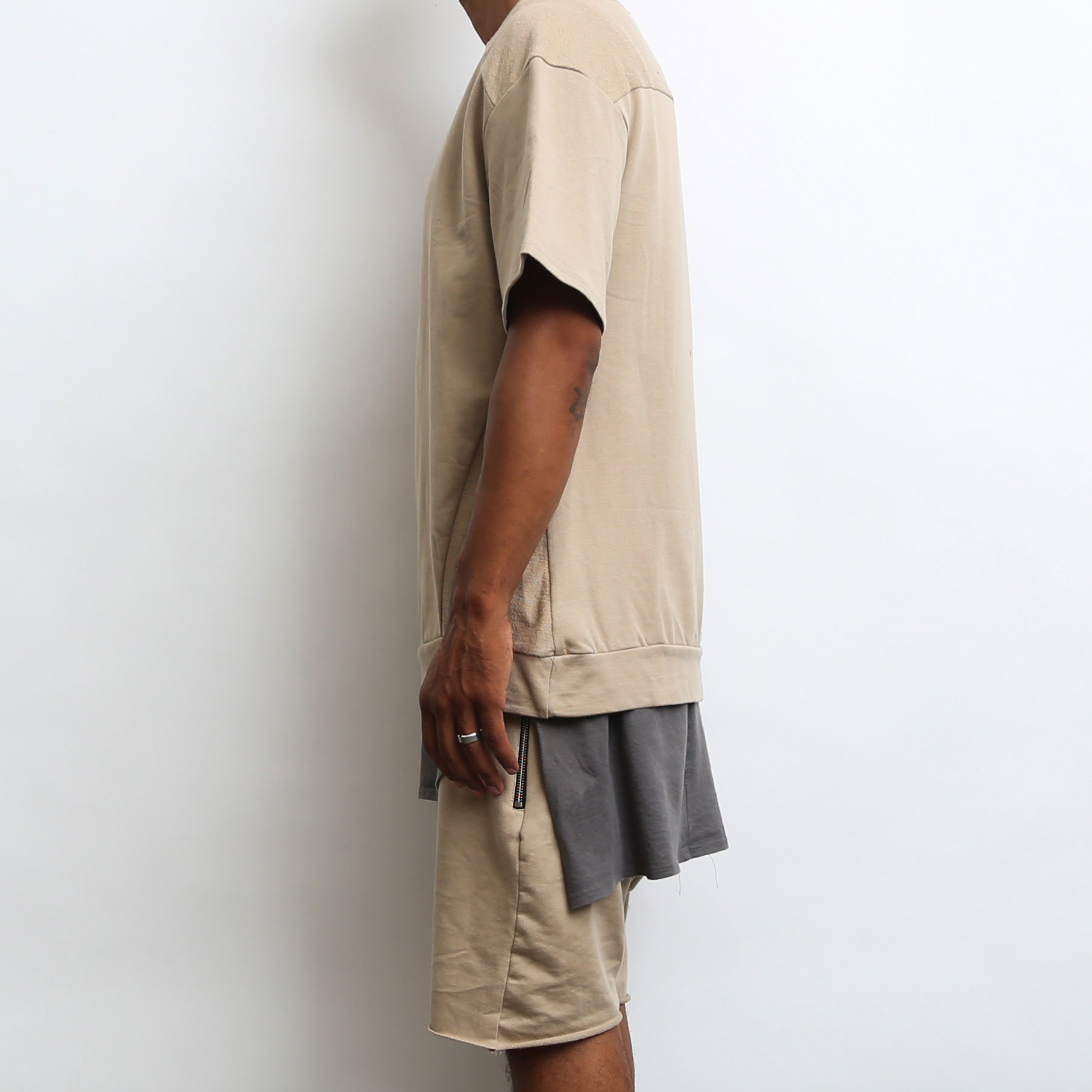 Khaki oversized 1/2 sleeve tee made from 100% cotton, showcasing a relaxed fit and stylish design.