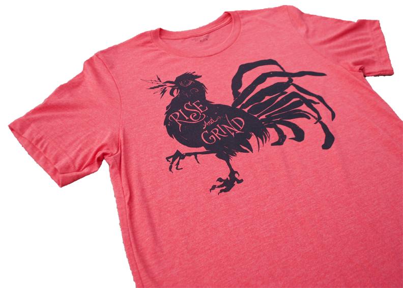 Rise and Grind Heather Red T-shirt displayed on a wooden surface, showcasing its soft fabric and vibrant color.