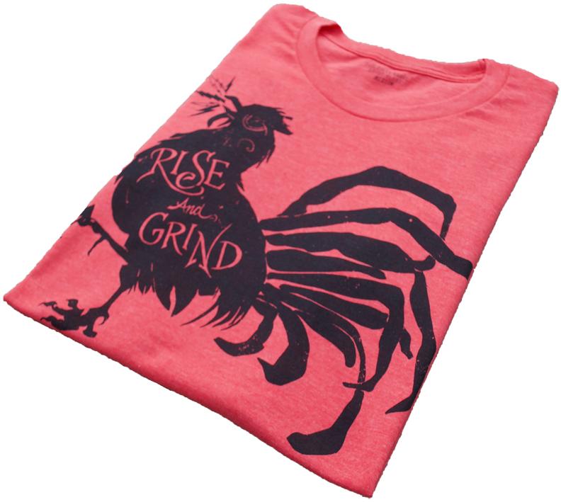 Rise and Grind Heather Red T-shirt displayed on a wooden surface, showcasing its soft fabric and vibrant color.