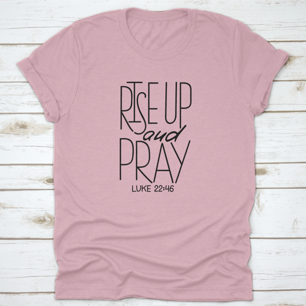 Rise Up And Pray T-Shirt featuring an inspirational quote design, made from soft cotton fabric, displayed on a neutral background.