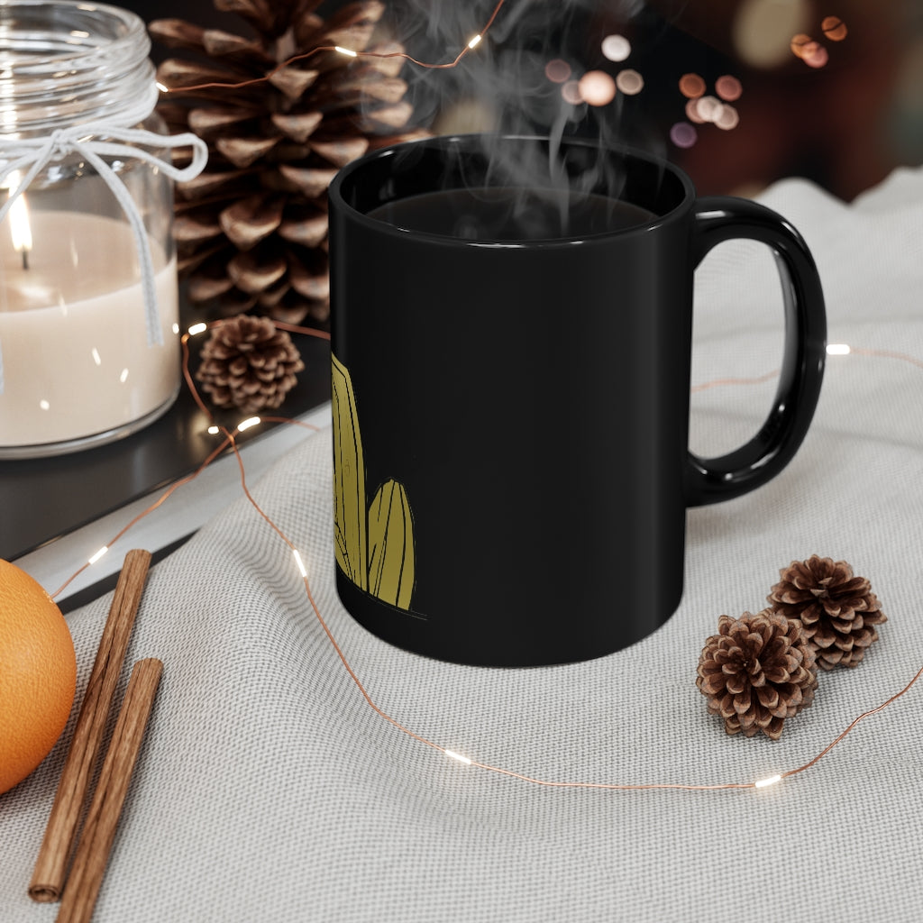 A sleek black ceramic mug with a C-handle, perfect for coffee, tea, or hot chocolate, showcasing its 11oz capacity.