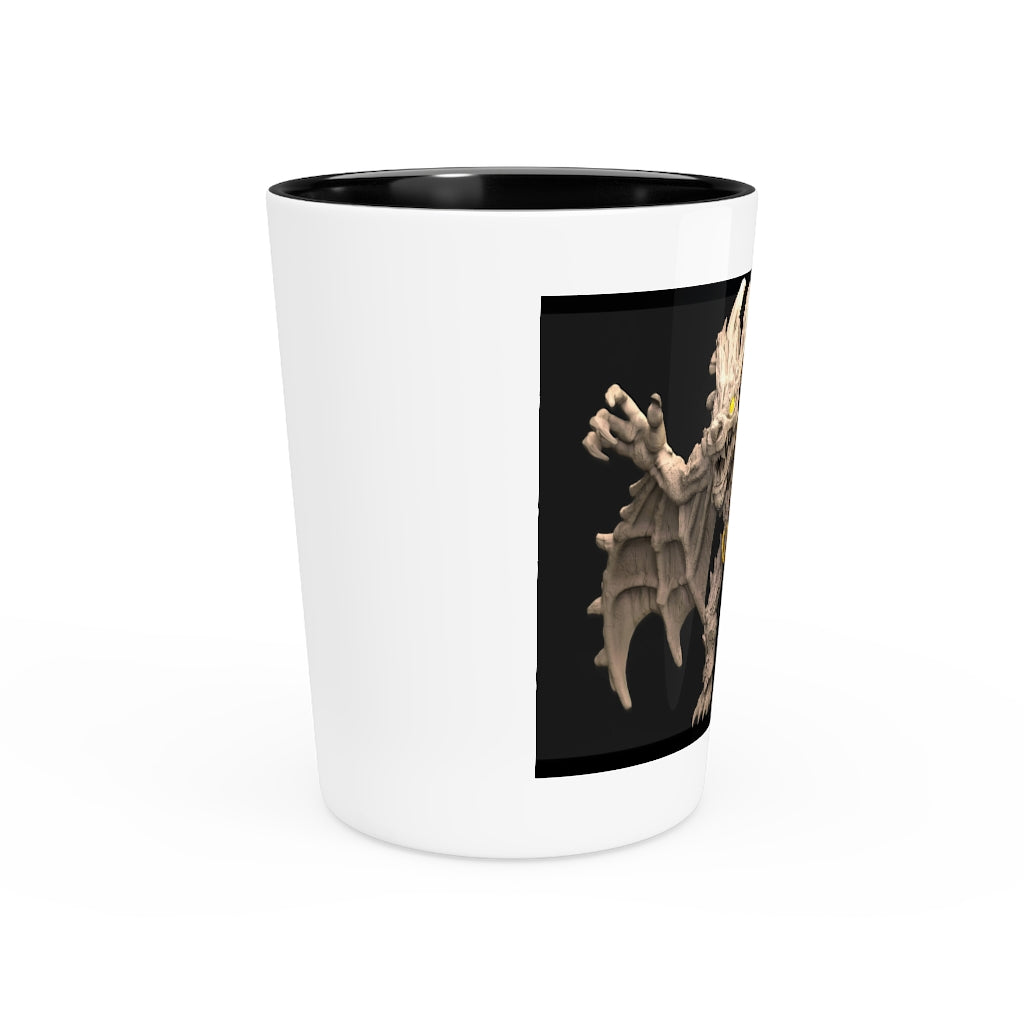 A personalized Rock Creature Shot Glass made of white ceramic with a customizable black or white interior, perfect for gatherings and gifts.