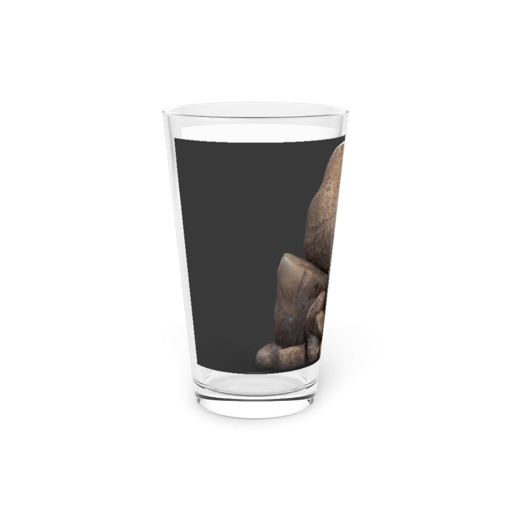 A clear 16oz Rock Pint Glass showcasing its elegant design, perfect for personalized drinks.