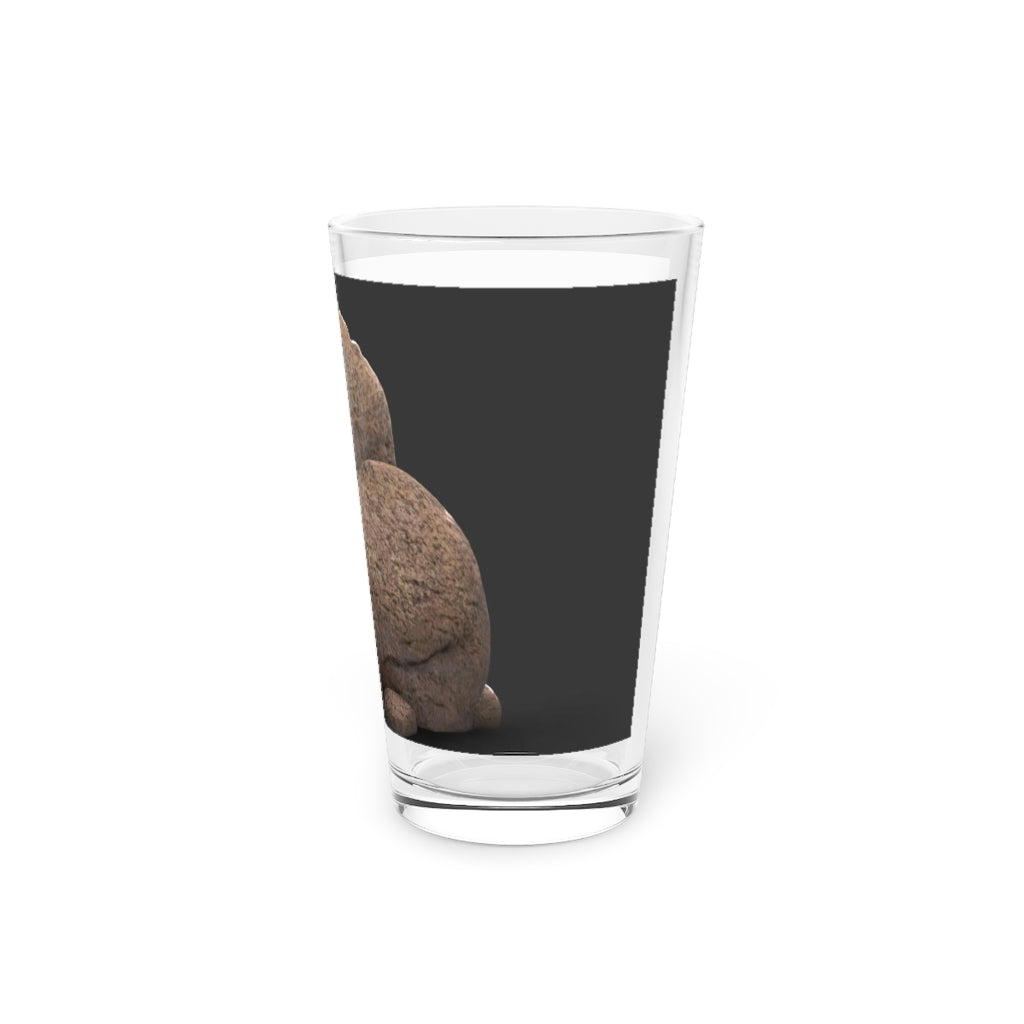 A clear 16oz Rock Pint Glass showcasing its elegant design, perfect for personalized drinks.