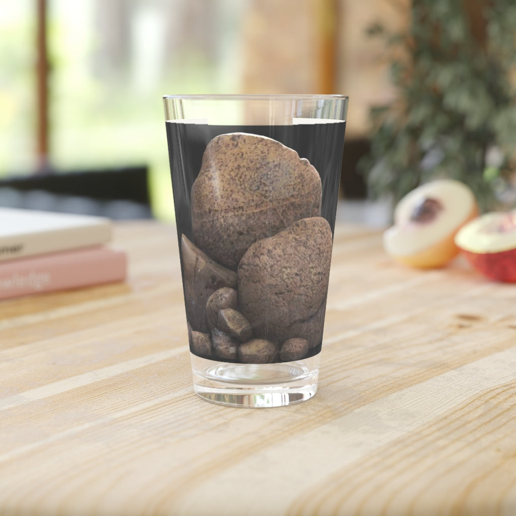 A clear 16oz Rock Pint Glass showcasing its elegant design, perfect for personalized drinks.