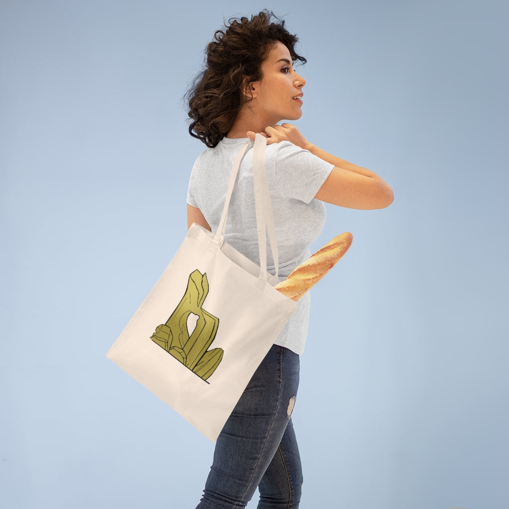 A stylish Rock Tote Bag made of 100% cotton, featuring long handles and cross stitching for added stability, available in various colors.