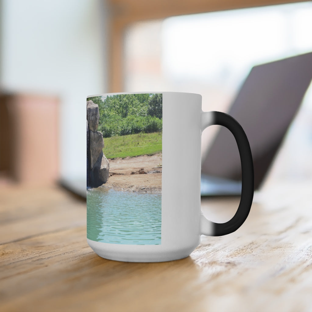 A white ceramic mug featuring a rock waterfall design that changes color when filled with hot liquid, available in 11oz and 15oz sizes.