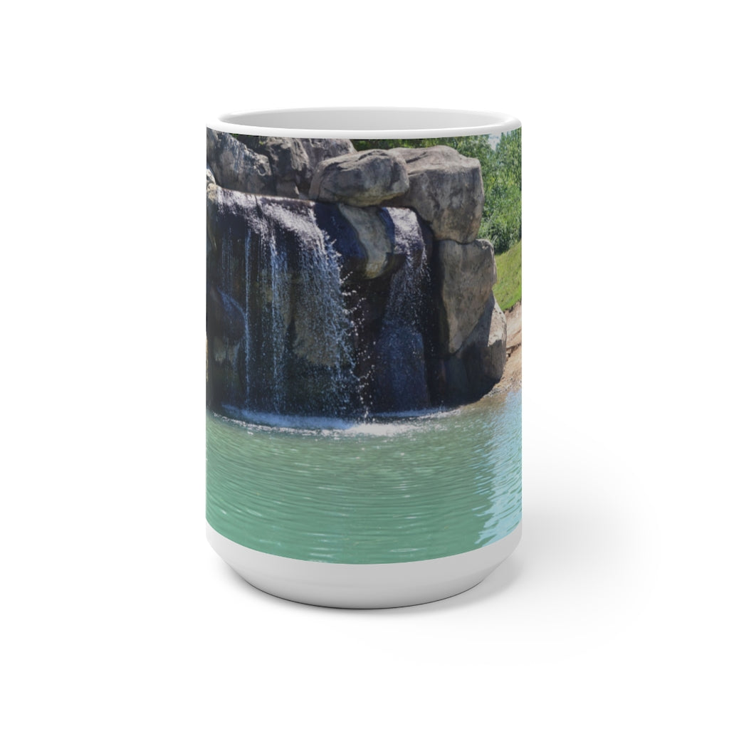 A white ceramic mug featuring a rock waterfall design that changes color when filled with hot liquid, available in 11oz and 15oz sizes.