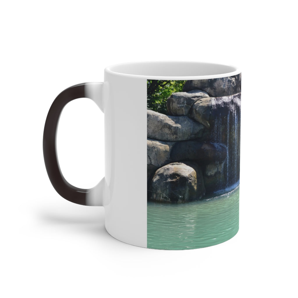 A white ceramic mug featuring a rock waterfall design that changes color when filled with hot liquid, available in 11oz and 15oz sizes.