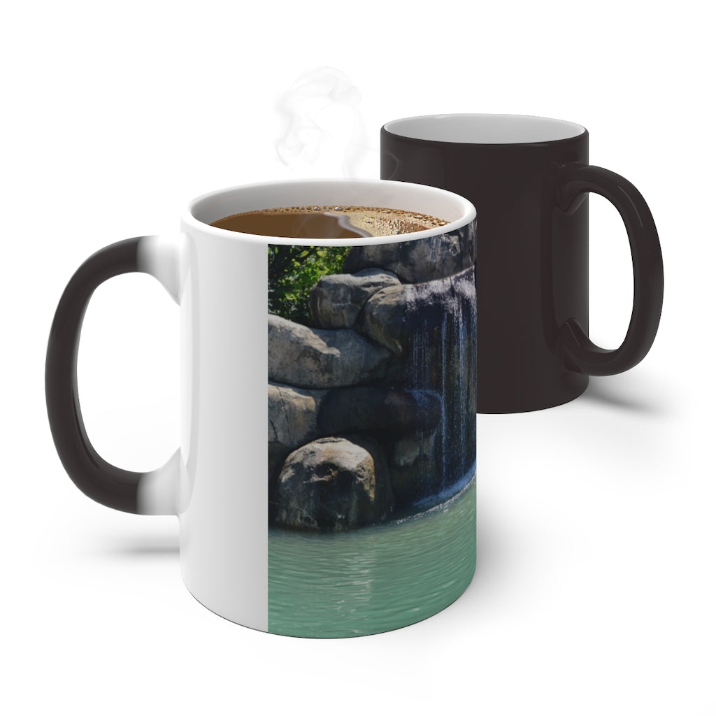 A white ceramic mug featuring a rock waterfall design that changes color when filled with hot liquid, available in 11oz and 15oz sizes.