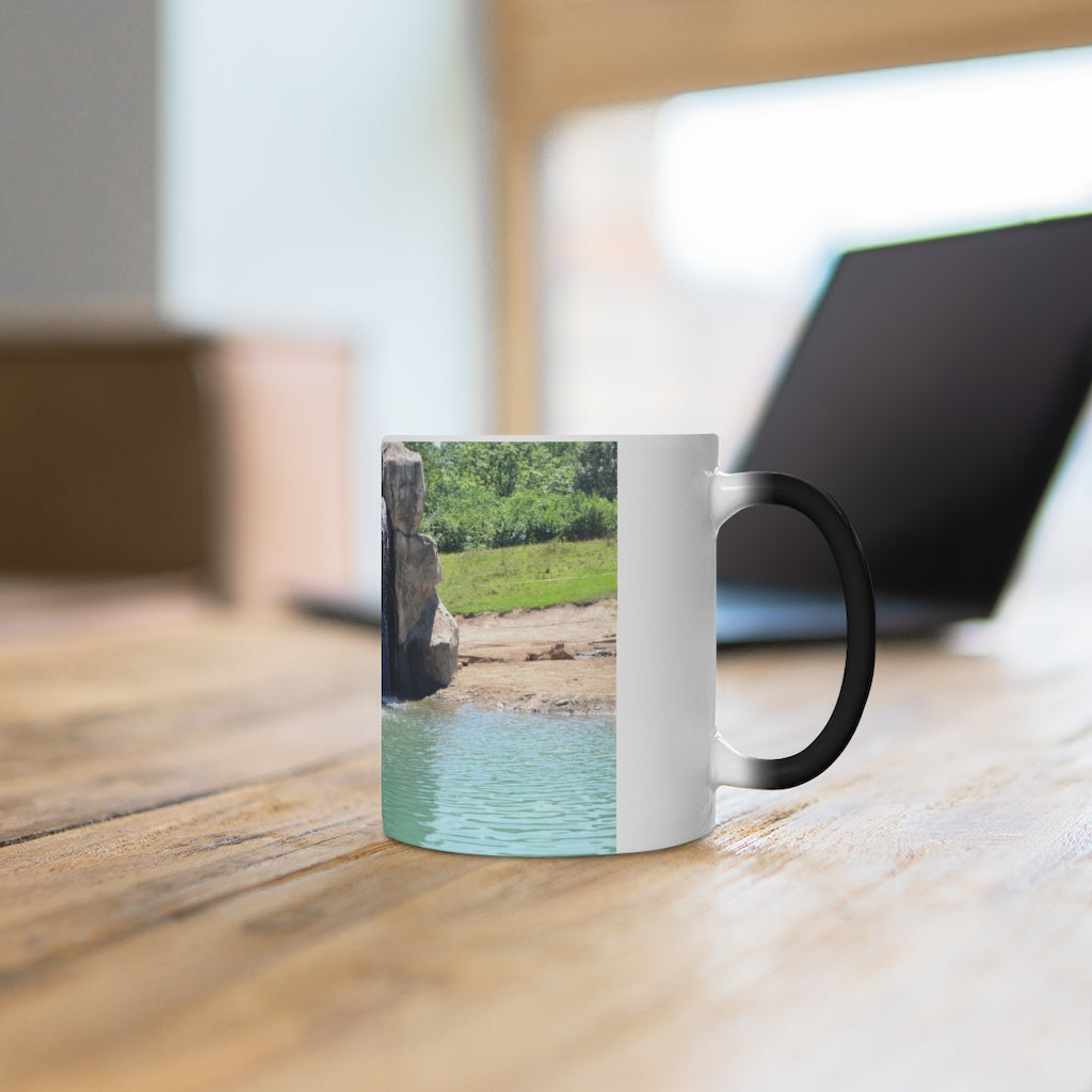 A white ceramic mug featuring a rock waterfall design that changes color when filled with hot liquid, available in 11oz and 15oz sizes.