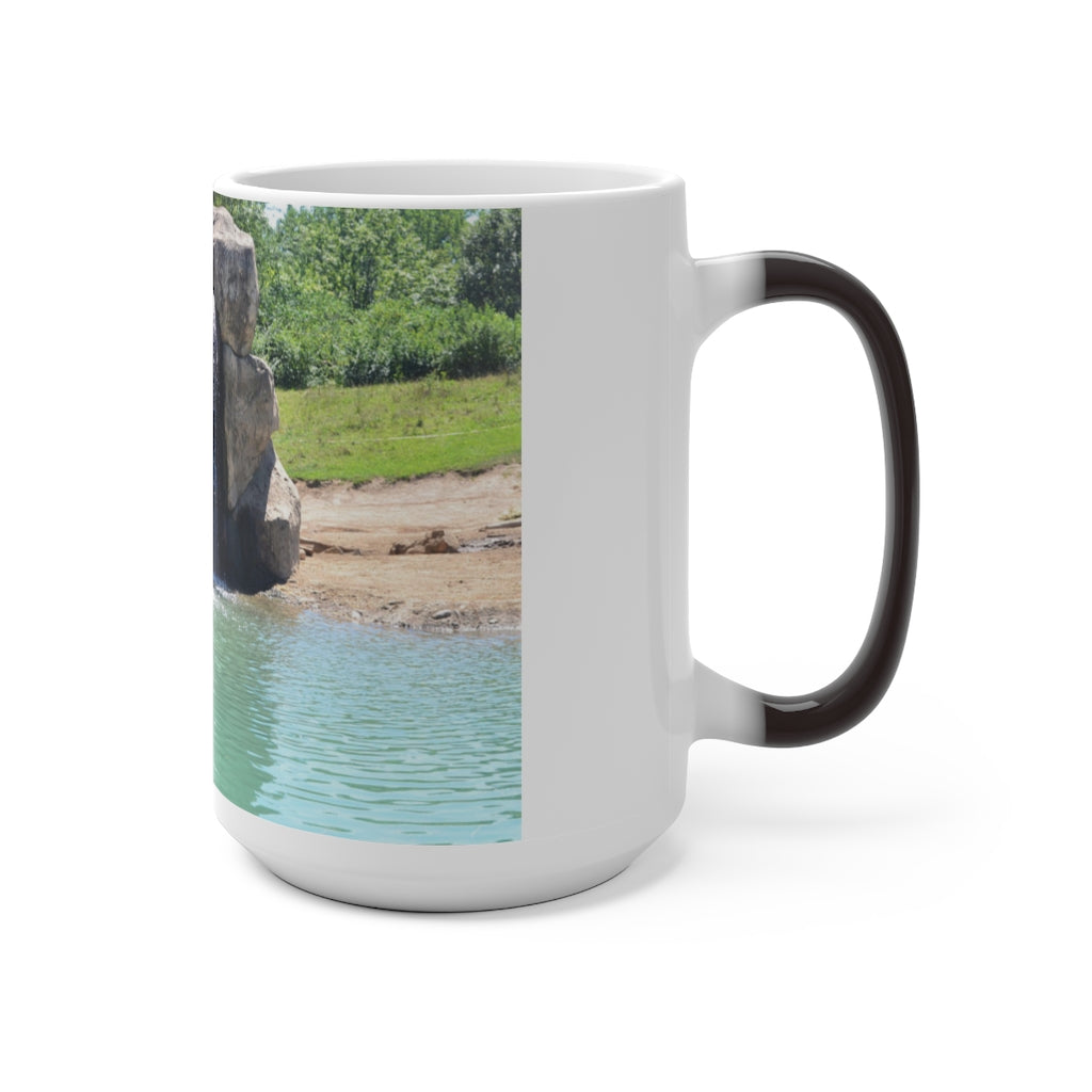 A white ceramic mug featuring a rock waterfall design that changes color when filled with hot liquid, available in 11oz and 15oz sizes.