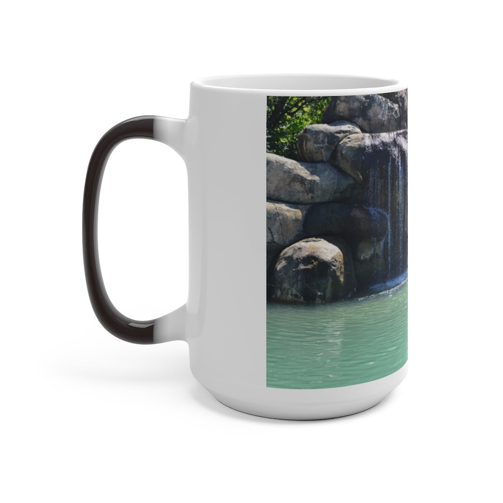 A white ceramic mug featuring a rock waterfall design that changes color when filled with hot liquid, available in 11oz and 15oz sizes.