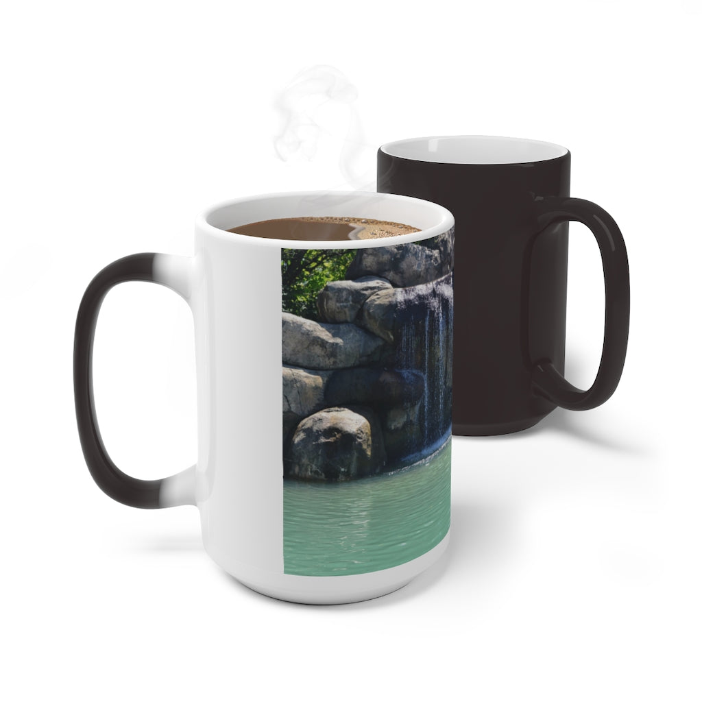 A white ceramic mug featuring a rock waterfall design that changes color when filled with hot liquid, available in 11oz and 15oz sizes.