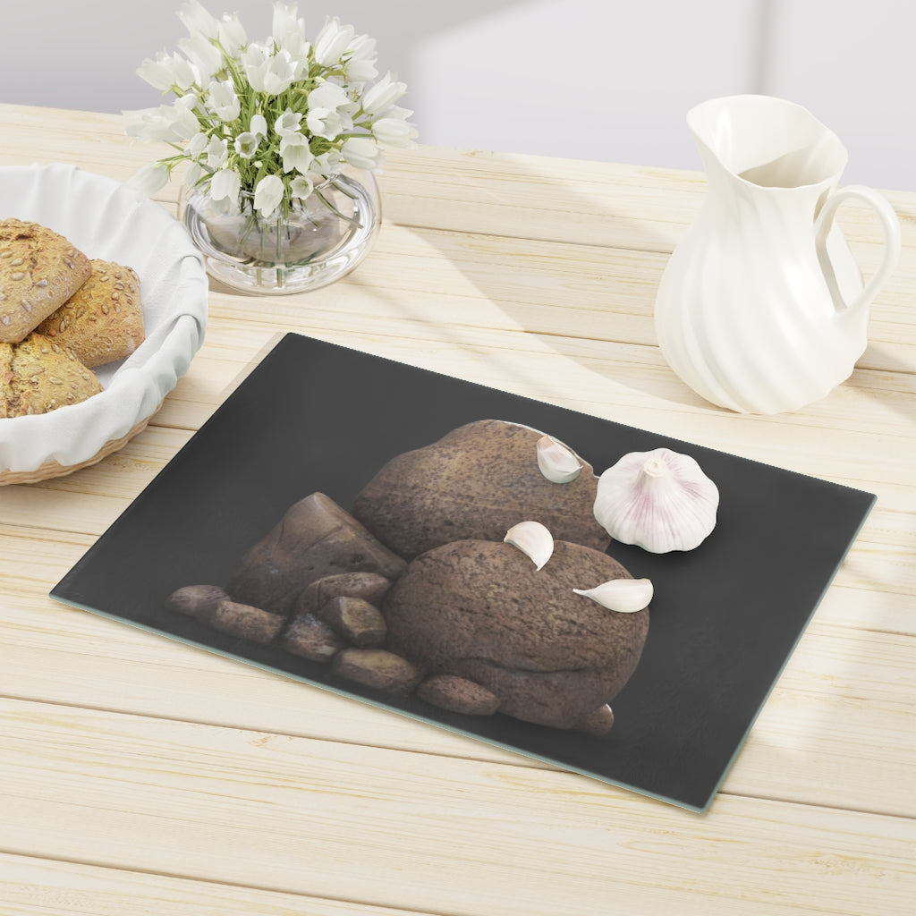 Rocks Cutting Board made of tempered glass with rubber dots for stability, showcasing a stylish design.