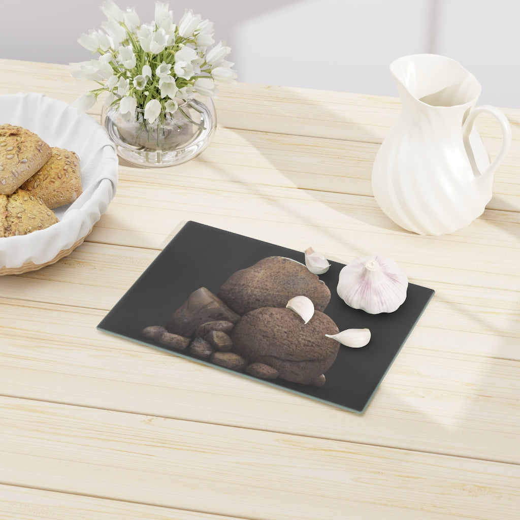 Rocks Cutting Board made of tempered glass with rubber dots for stability, showcasing a stylish design.