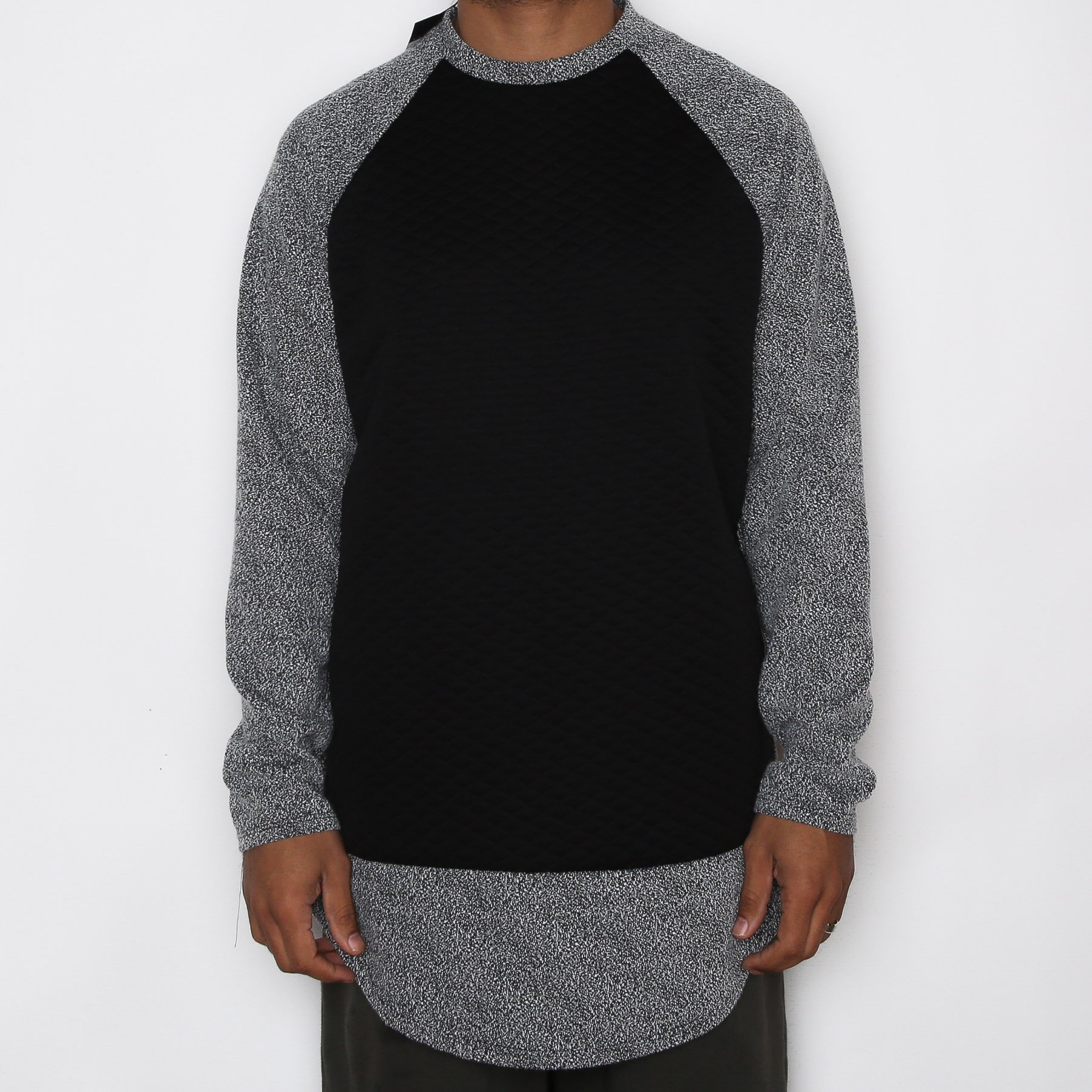 A stylish black scallop baseball tee featuring a quilted body and textured sleeves, perfect for casual wear.