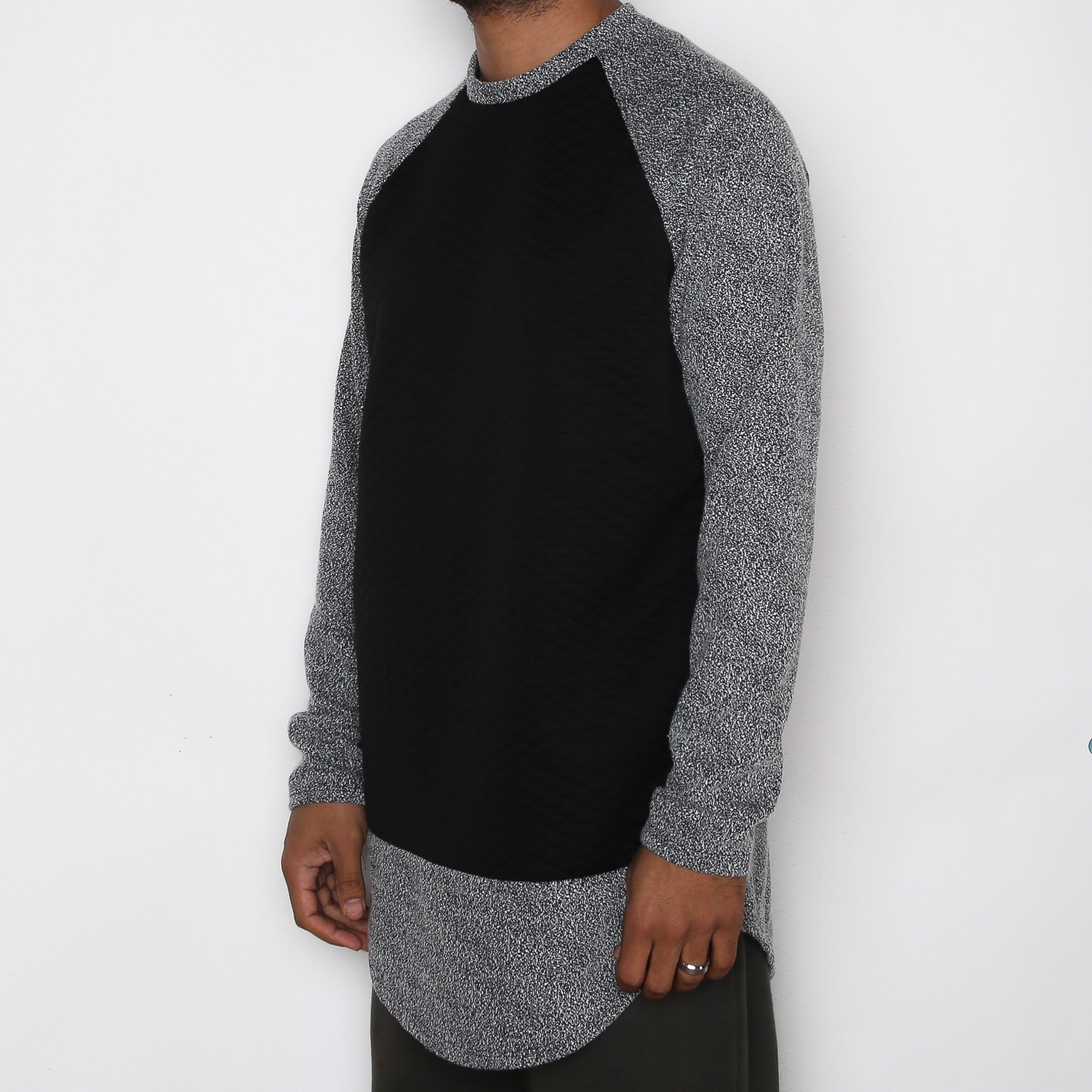 A stylish black scallop baseball tee featuring a quilted body and textured sleeves, perfect for casual wear.