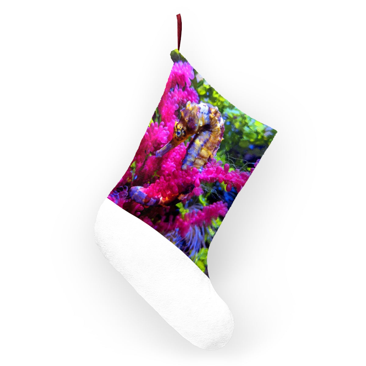 A cozy Seahorse Christmas Stocking made of soft polyester fleece, featuring a festive design and a twill ribbon hanging loop.