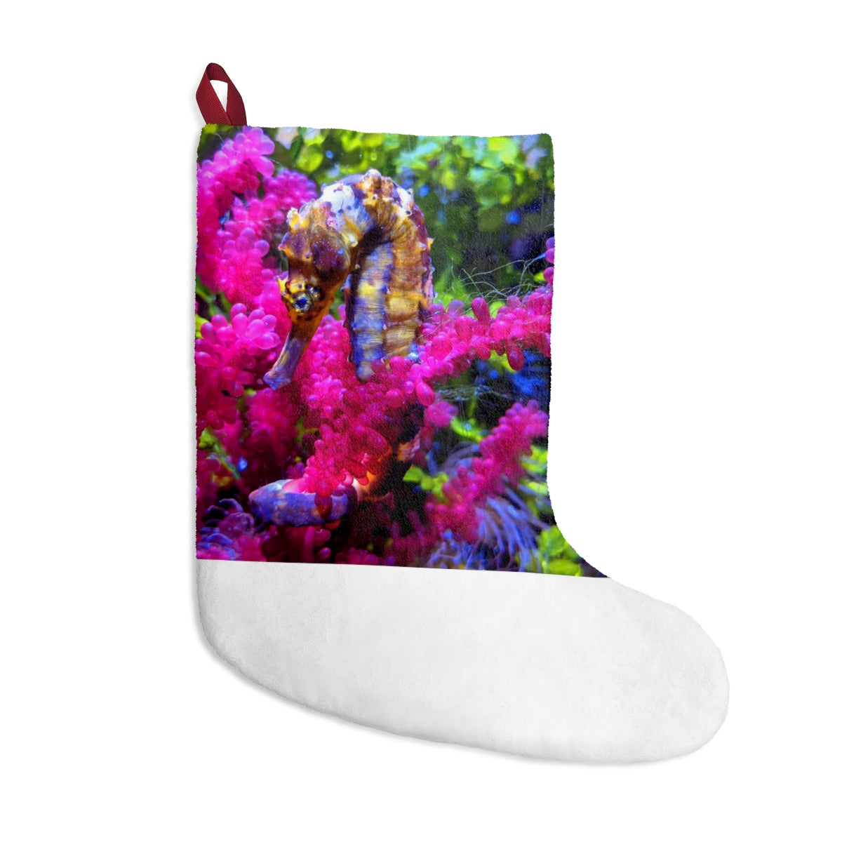 A cozy Seahorse Christmas Stocking made of soft polyester fleece, featuring a festive design and a twill ribbon hanging loop.