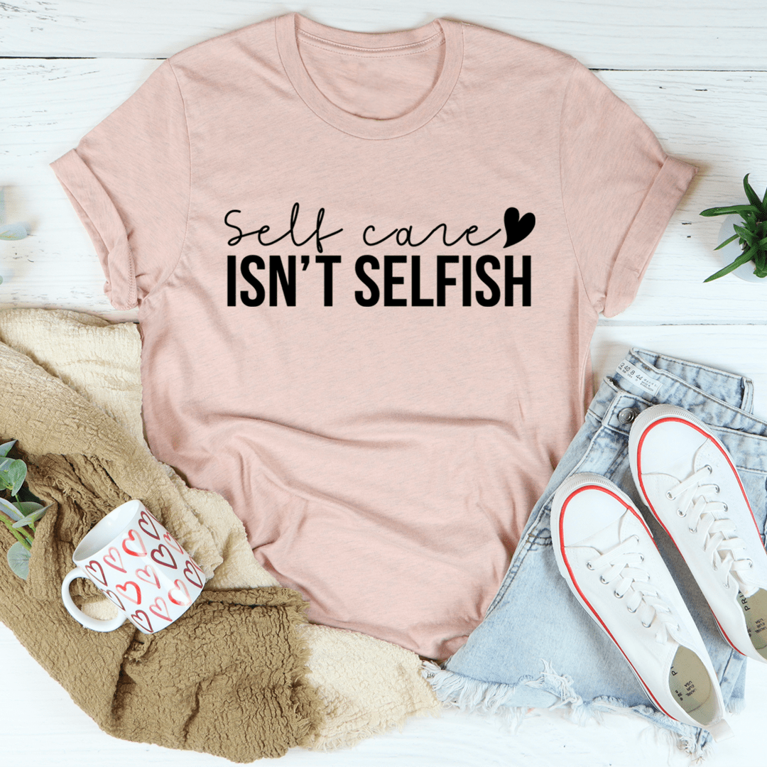 A comfortable and stylish 'Self Care Isn't Selfish' T-Shirt made from soft ring-spun cotton, featuring a durable design and a positive message.