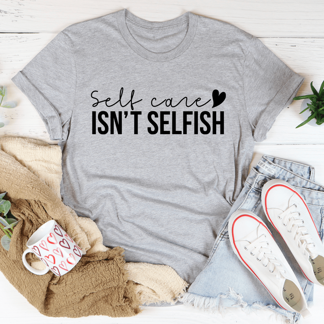 A comfortable and stylish 'Self Care Isn't Selfish' T-Shirt made from soft ring-spun cotton, featuring a durable design and a positive message.