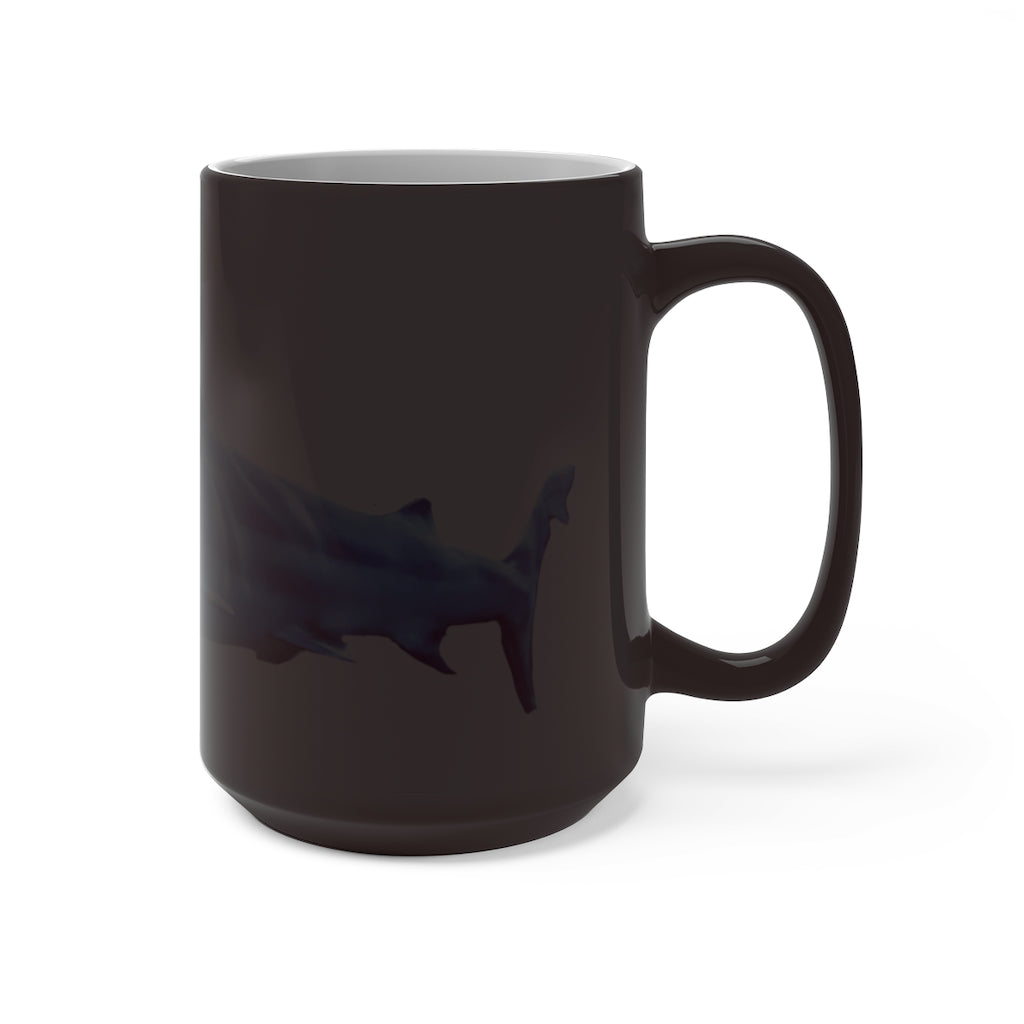 A white ceramic mug featuring a shark design that changes color when filled with hot liquid, showcasing its playful and magical feature.