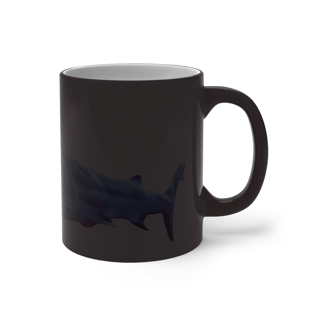 A white ceramic mug featuring a shark design that changes color when filled with hot liquid, showcasing its playful and magical feature.