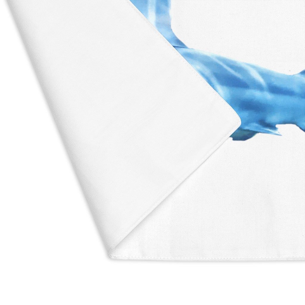 A colorful shark-themed placemat made of durable cotton, featuring a playful design on one side and a natural back.