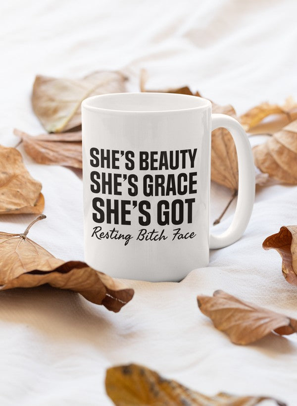 A stylish 11oz mug with a glossy finish featuring the phrase 'She's Beauty She's Grace' and a sturdy handle.