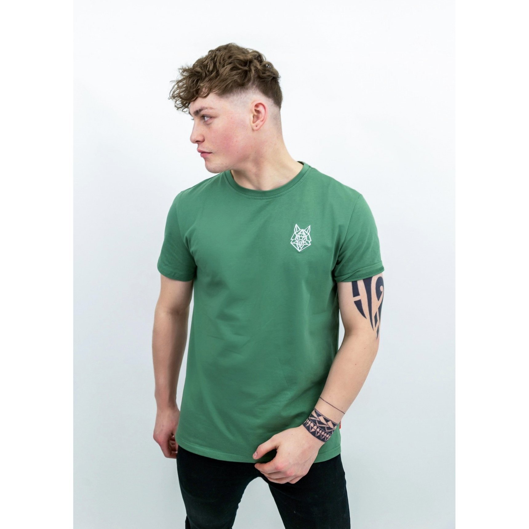 A fitted green T-shirt featuring a white embroidered Wolfe logo on the left chest, made from soft cotton and spandex.