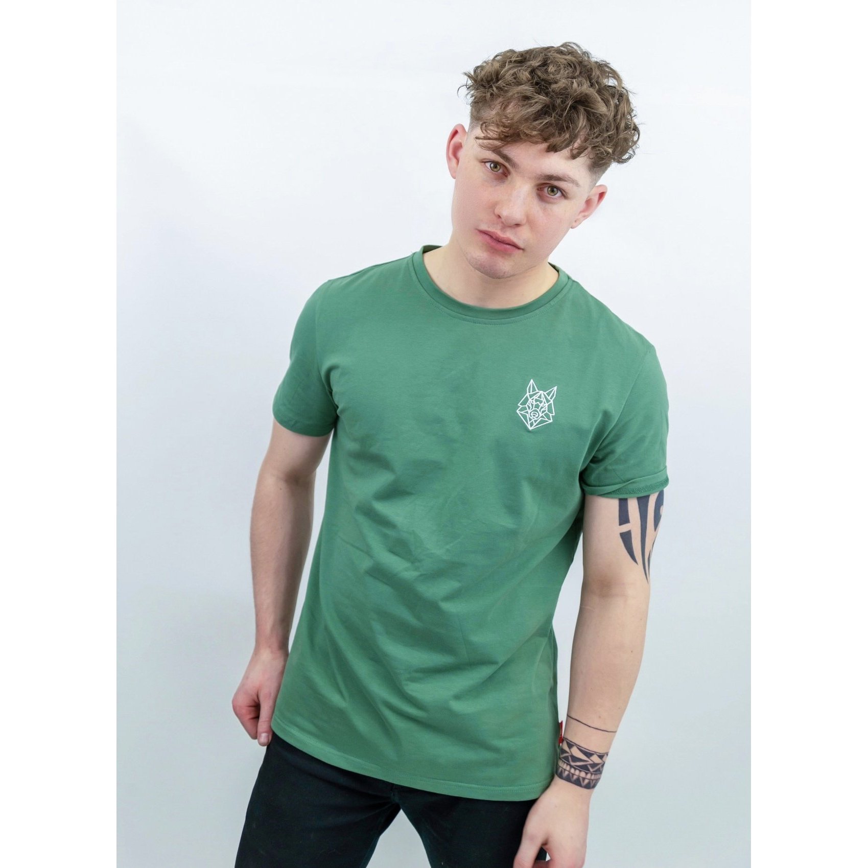 A fitted green T-shirt featuring a white embroidered Wolfe logo on the left chest, made from soft cotton and spandex.