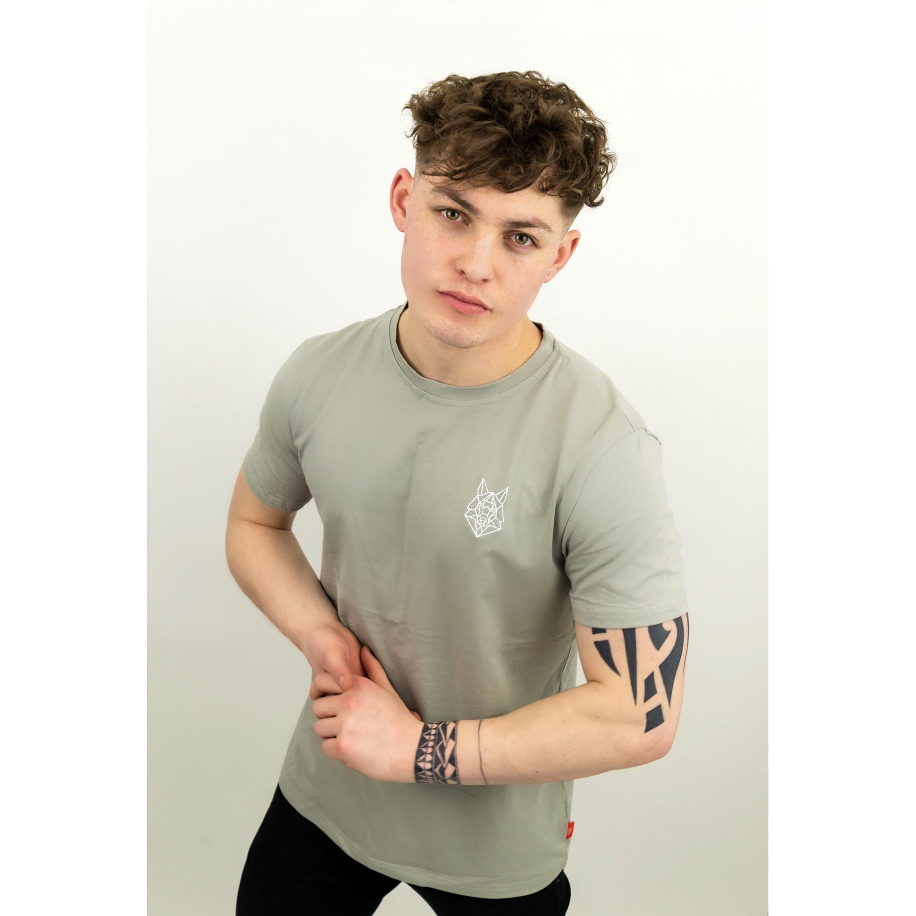 A fitted grey t-shirt featuring a white embroidered Wolfe logo on the left chest, made from a soft cotton and spandex blend.